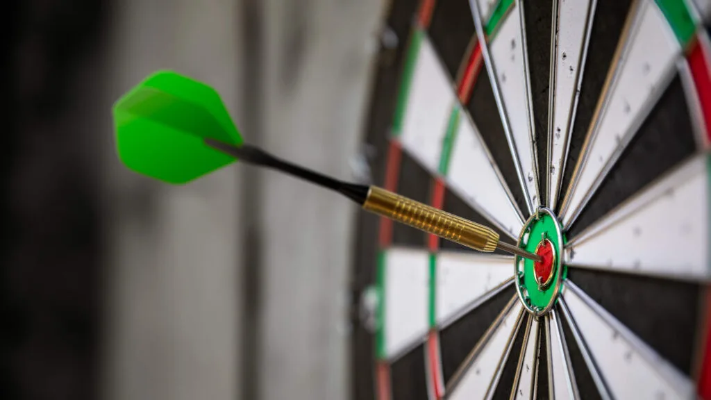 a typical darts game with dart in the bullseye TS8BP9Y