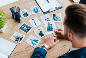 selective focus of recruiter holding photo small